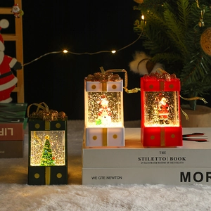 Lighted Christmas water lanterns with Santa, Snowman, and Tree designs in a gift box
