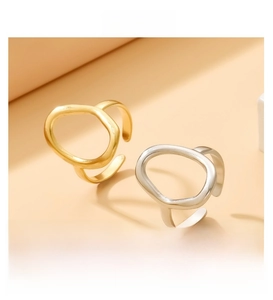 Close-up of gold and silver open rings with minimalist hollow oval geometric design