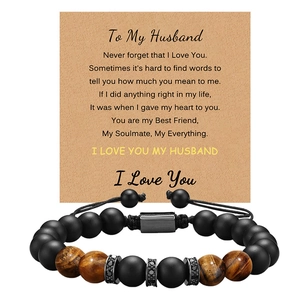 Detail of tiger eye and matte stone bead bracelet with micro-pave charms and gift card