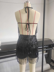 Back view of a black sequin fringe two-piece set with sexy tie-up lace-up detail