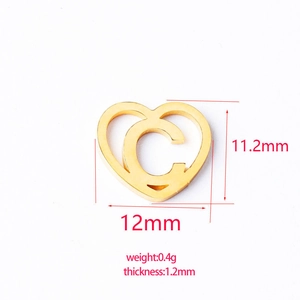 Detailed view of a golden heart pendant with letter C engraving and size measurements