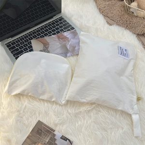 Detailed view of white waterproof travel organizers with yellow zippers on a cozy rug