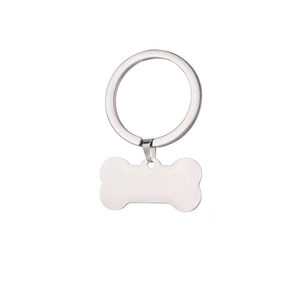 Close-up of bone-shaped stainless steel pet ID tag with a matte silver finish