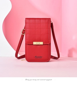Detailed view of red quilted leather phone bag featuring a golden metal twist lock