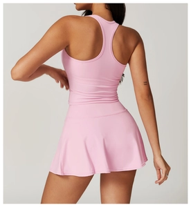 Rear view of pink racerback sports top and pleated tennis skirt set for women