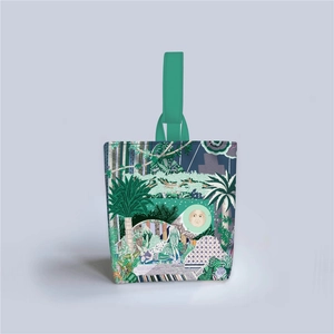 Detail of the tropical jungle illustration and green handle on the fabric tote bag