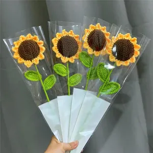 Handcrafted crochet sunflower bouquet with four stems in elegant clear gift packaging