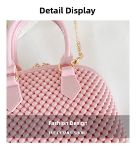 Detail of pink beaded shell bag showing woven texture and gold chain strap