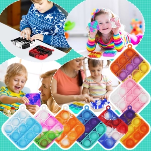 Close-up of 3x3 silicone bubble pop fidget toy in vibrant rainbow and camo colors