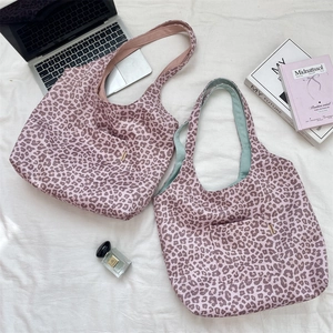 Detail of leopard print tote bags with front pocket and colorful lining options