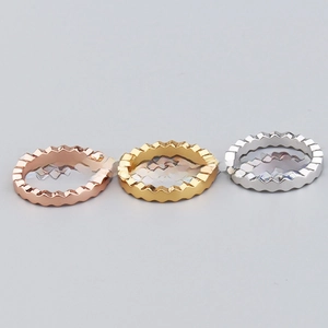 Detailed view of wave-shaped geometric rings in rose gold, gold and silver finishes