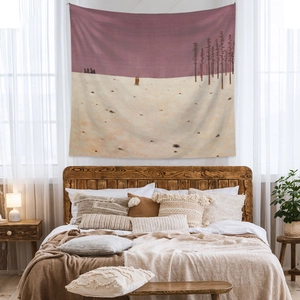 Detail of bohemian winter landscape tapestry displayed in a cozy bedroom setting