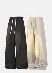 Detailed view of elastic drawstring waistband on minimalist wide leg trousers
