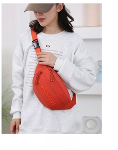 Fashionable bright orange canvas crossbody chest bag for women with adjustable strap