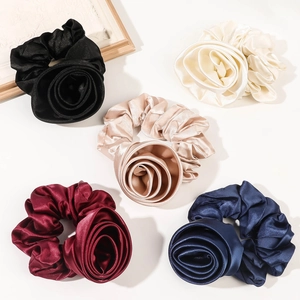 Five-piece set of satin floral scrunchies in black, white, champagne, red, and navy blue