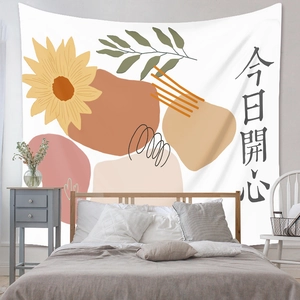 Bohemian tapestry featuring sunflowers and artistic calligraphy on a bedroom wall