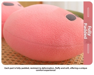 Close-up of pink cherry plush pillow showing soft grainy fleece texture and firm filling