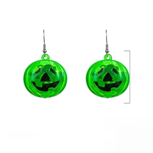 Close-up of LED glowing pumpkin earrings with detailed Jack-o'-lantern face engravings
