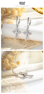 Detail showing silver cross hoop earrings with micro-inlaid white zircon and shiny finish