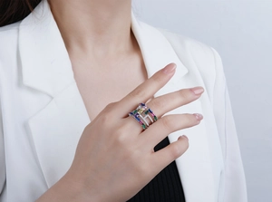 Detailed close-up of multi-layer silver ring with colorful rectangular cubic zirconia stones