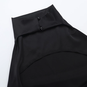 Detail of a chic black halter neck dress featuring a stand collar and backless cutout design