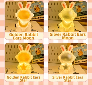 Close-up of four astronaut night lights with rabbit ears in gold and silver moon styles