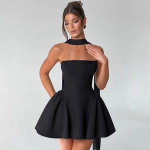 Detail of black strapless mini dress featuring a halter neck ribbon and tiered skirt