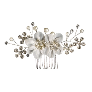 Detailed view of handmade bridal hair comb with white fabric flowers and rhinestones