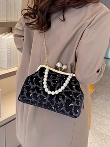 Vintage black velvet shell bag with gold metallic frame and pearl strap detail