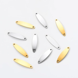 Macro shot of oval stainless steel jewelry connectors with double holes in gold and silver
