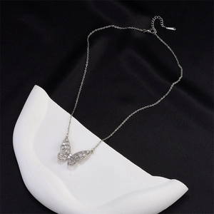 Elegant silver butterfly pendant necklace with zircon stones on premium black silk backdrop