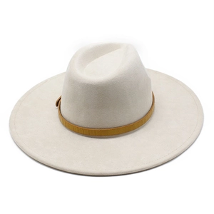 Close-up of a white wide-brim suede fedora featuring a decorative brown textured band