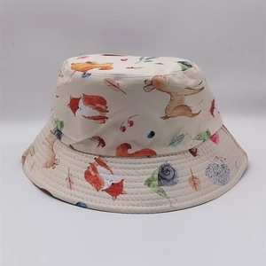 Detail of forest animal print on cotton bucket hat featuring fox and deer motifs