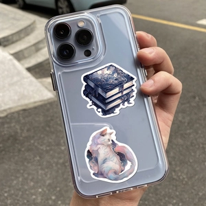 Detail of waterproof realistic witch stickers with blue magic book and cosmic cat on phone case