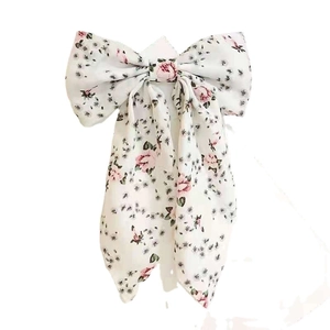 Floral print bow hair clip with long ribbons featuring pink flowers on white fabric
