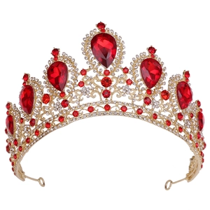 Close-up of golden bridal crown featuring large red gems and sparkling rhinestones