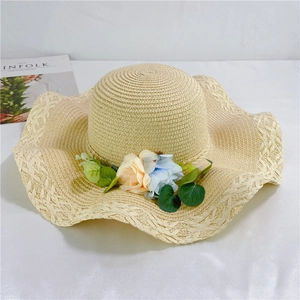 Detail of a straw sun hat featuring delicate floral accents and wavy woven edges