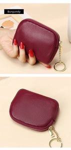 Detailed claret leather coin purse featuring a pebble grain texture and gold zipper keychain