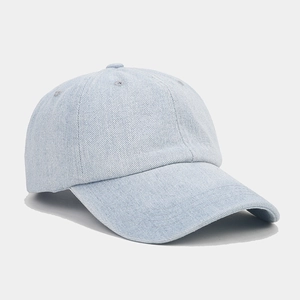 Detailed view of light blue denim baseball cap showing fabric texture and curved brim