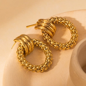 French vintage gold beaded hoop earrings with polished texture in a stone bowl