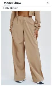 Detailed view of women's loose outdoor pants and jacket set in latte brown color