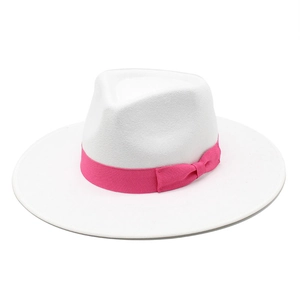 Detail of white wool fedora hat featuring a stylish rose pink ribbon with a bow