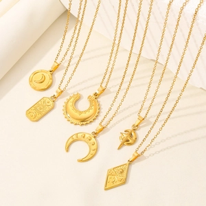 Detailed close-up of golden moon and tarot-style celestial pendants on a neutral background