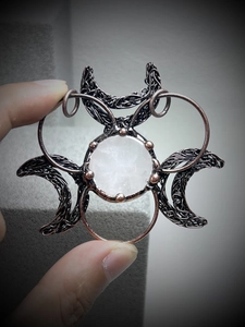Handmade copper wire-wrapped triple moon pendant featuring a natural white quartz crystal
