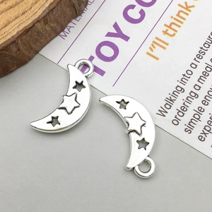 Macro shot of silver crescent moon pendant with star cutout and 925 stamp detail