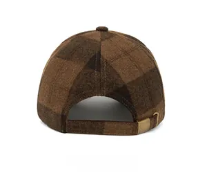 Detail of checkered wool baseball cap showing adjustable metal buckle and neat stitching