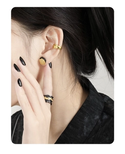 Detail of S925 silver stud earring with unique rock texture and black-gold finish