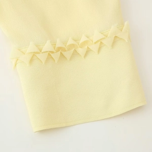 Pale yellow pleated chiffon V-neck blouse featuring unique ruffled sleeve cuff detail