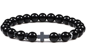 Detail of hematite cross charm and polished black beads on a men's beaded bracelet