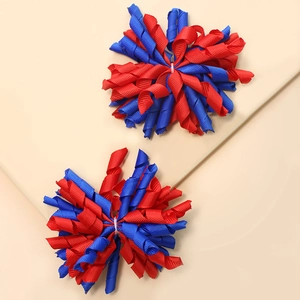 Handmade curly grosgrain ribbon hair clips for kids in vibrant red and blue colors